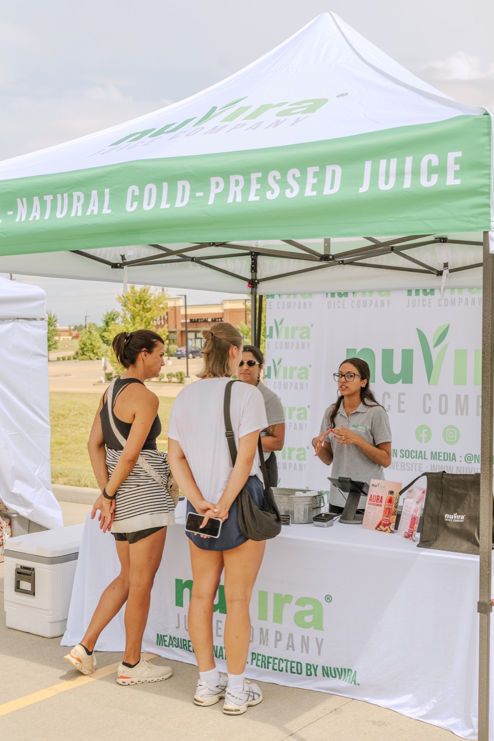 NuVira team serving customers at a community event booth