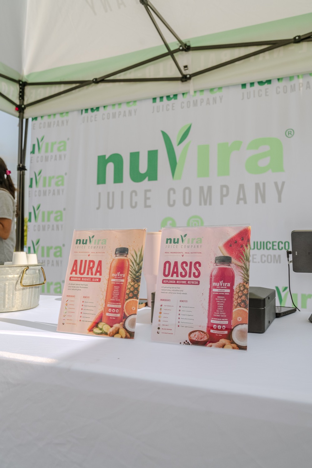 NuVira product menus and booth signage at a local event