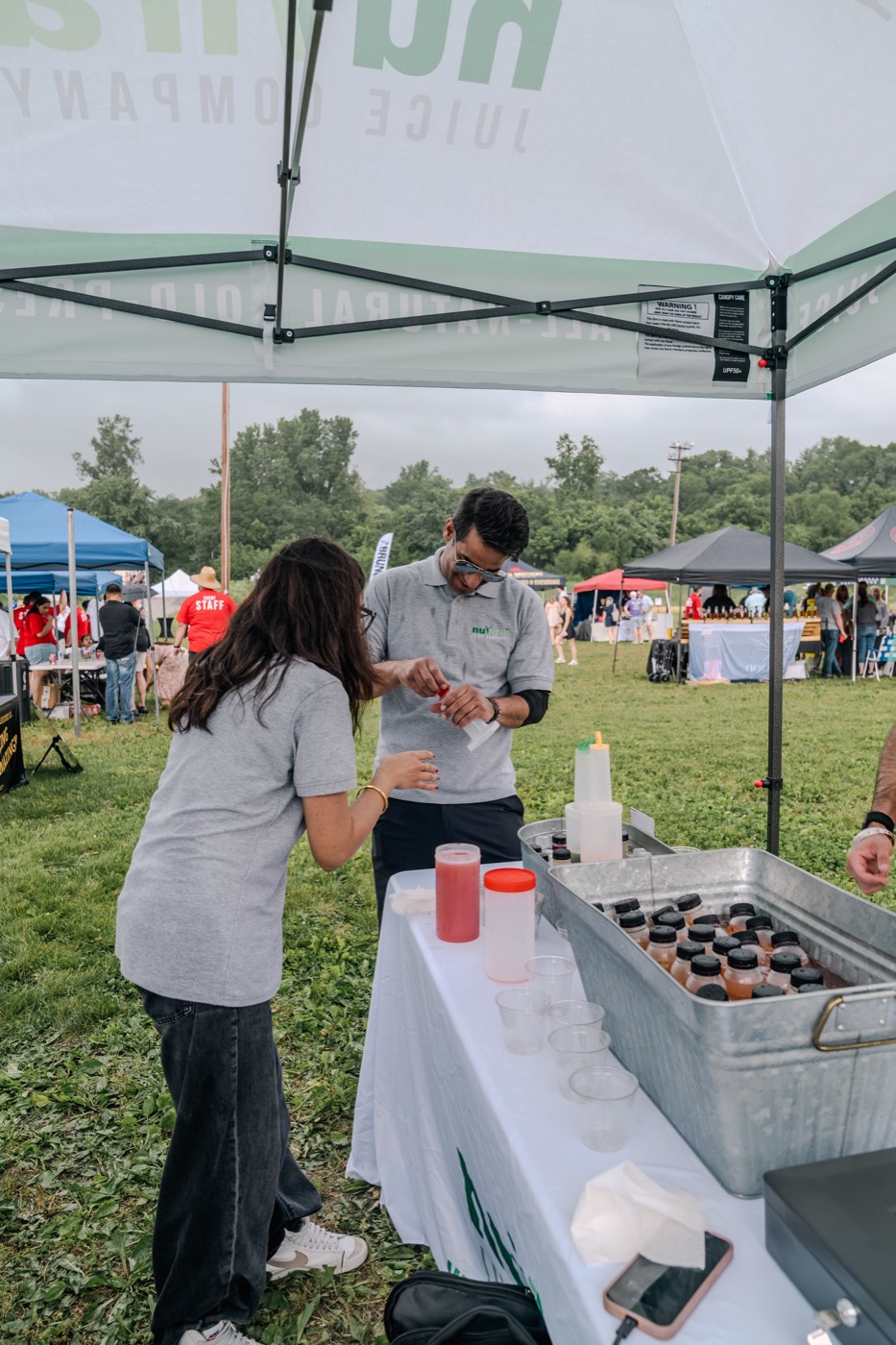 NuVira serving fresh juice samples at a local event